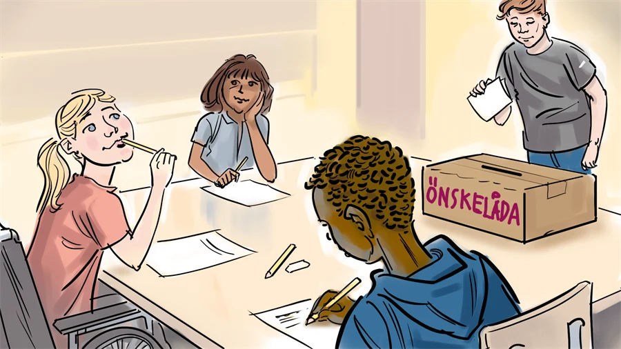 Flera barn runt ett bord med en låda som det står önskelåda på.